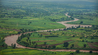 Aerial view of a river winding through farmland