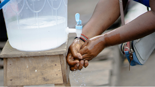 Washing hands at a clean water station