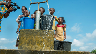 Children collecting water in buckets