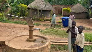 Hand pump well beside village homes